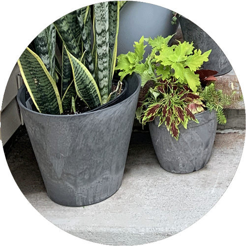 Gray Artstone planters in two different sizes.